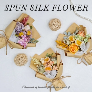 Artistic layout of three mini spun silk flower bouquets in kraft paper wrapping