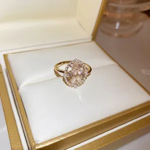 Elegant gold flower ring featuring cat eye stones, white pearls, and sparkling crystals