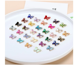 Close-up of colorful crystal butterfly charms with gold metal base for DIY jewelry