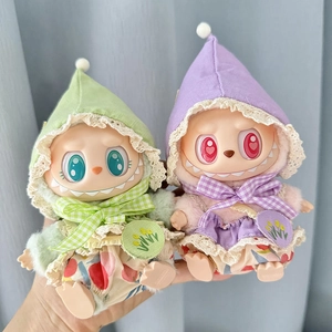 Detail of plush dolls wearing green and purple plaid hoodies with delicate lace and bows