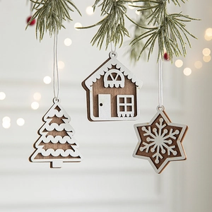 Wooden Christmas hanging ornaments featuring tree, house and snowflake on pine branch