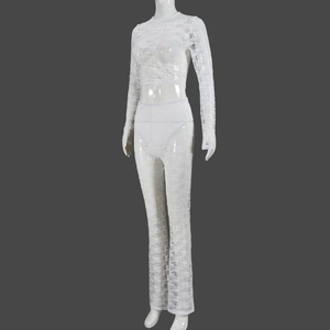 Detail of white lace hollow-out long sleeve crop top and matching flare pants set