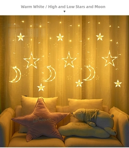 Detail view of warm white LED curtain lights with star and moon hanging shapes