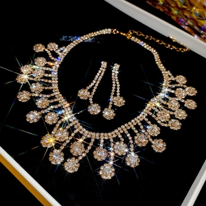 Macro detail of luxury flower tassel necklace and earrings set in a premium jewelry box