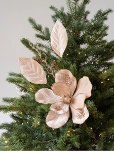 Close-up of champagne velvet magnolia with glitter on a decorated Christmas tree