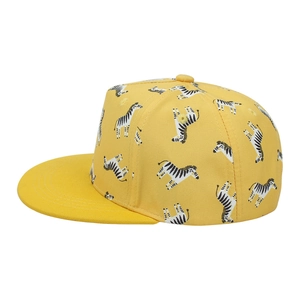Detailed side view of yellow kids flat brim baseball cap with cartoon zebra print pattern