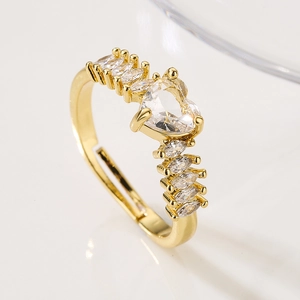 Detailed macro of gold heart zircon ring with marquise side stones and adjustable band