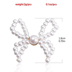 Macro detail of faux pearl bow earring showing 1.8cm size and 2g weight parameters