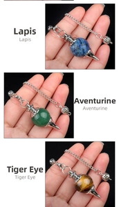 Detail view of natural Lapis, Aventurine, and Tiger Eye crystal stone pendulum pendants