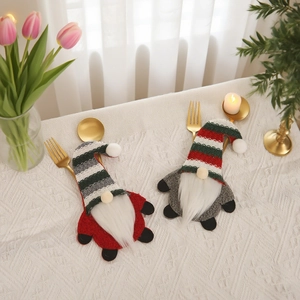 Gnome Christmas cutlery holders with knitted striped hats for festive table decoration