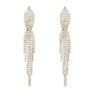 Close-up of gold tassel drop earrings with white crystal rhinestones for women