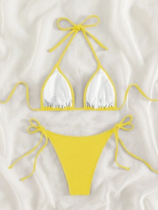 Detailed flat lay of vibrant yellow ribbed bikini featuring side-tie bottoms and white lining