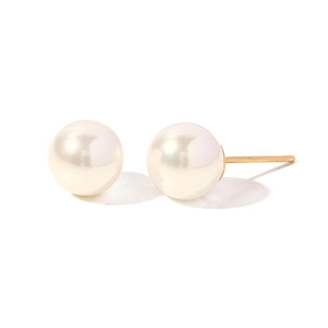 Detail view of round white pearl earrings with gold pins on a clean white background