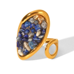 Macro detail of gold-plated stainless steel ring with colorful natural crushed stone inlay