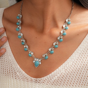 Detailed shot of Bohemian vintage necklace with turquoise stones and silver-tone water drops