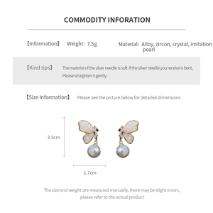 Detail view of butterfly earrings with cubic zirconia, crystals, and faux pearls at 3.5cm height