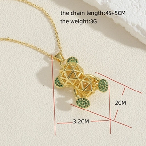 Detail of 14K gold hollow bear pendant with green zircons and measurement specs