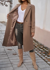Detail shot of a mid-length brown wool coat with a classic lapel and beige suede tall boots