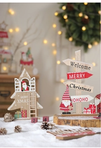Detail of wooden Christmas tree decor with Merry Christmas sign on faux snow background