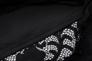 Detailed close-up of intricate black lace stitching and knit lining on a women dress
