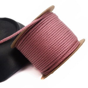 Close-up of 1.5mm dusty pink cotton cord roll for DIY jewelry weaving and beading