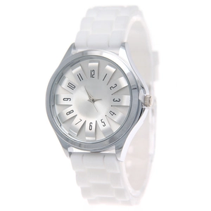 Detail shot of white silicone strap and silver watch dial with Arabic numerals