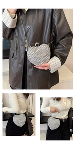 Silver heart-shaped rhinestone evening bag shown with chain strap and ring handle