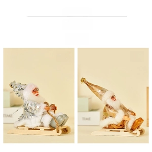 Detail showing gold and silver Santa Claus plush toys on wooden sleds with bells