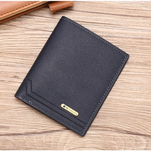 Close-up of slim blue PU leather men's wallet with metal logo and stitching on wood table