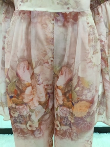 Detail of floral chiffon fabric texture and high waist design on summer wide leg pants