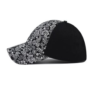 Distressed baseball cap featuring black and white paisley pattern with a solid black back