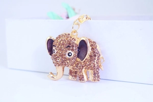 Detailed view of a golden elephant keychain with sparkling brown rhinestones and enamel accents