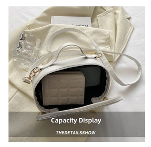 White barrel crossbody bag interior showing spacious capacity for wallet and electronics