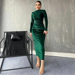Detail view of dark green velvet dress with elegant waist ruching and slim fit design
