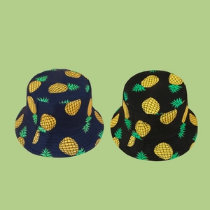 Tropical style bucket hats with yellow pineapple patterns in navy blue and black colors