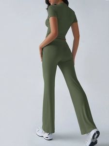 Rear view of an olive green two-piece yoga set with short sleeve top and flare pants