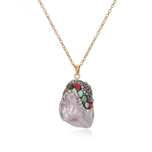Detailed close-up of light purple crystal pendant with colorful rhinestones on gold chain