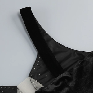 Close-up of black velvet straps and sheer mesh fabric with sparkling rhinestone accents