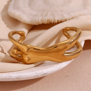 Close-up of 18K gold plated stainless steel cuff featuring creative body curve design