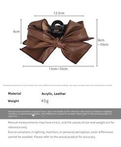 Detailed view of brown leather bow hair claw clip showing 12.5cm size and 45g weight