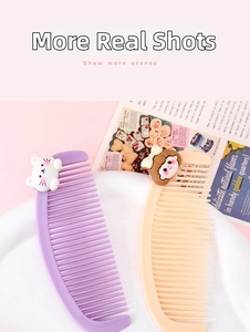 Detail of purple and beige crescent hair combs with cute cartoon cat and girl characters
