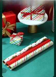 Detailed view of three-piece Christmas wrapping paper set with festive cartoon patterns