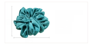 Detail of oversized cyan satin scrunchie with 18cm diameter and pleated polyester texture
