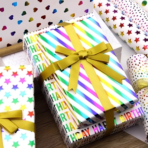 Detail of colorful laser gift wrapping paper with hearts, stars and stripes patterns