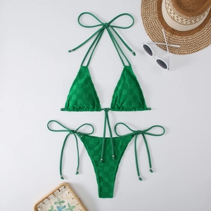 Detail view of emerald green bikini with textured fabric and metallic strap beads