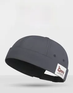 Detailed close-up of dark grey docker hat featuring camping patch and breathable eyelets
