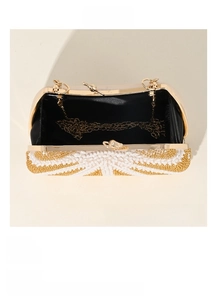 Internal structure of beaded evening clutch bag with chain strap and black lining