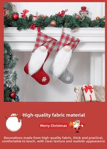 Detail of plush gnome Christmas stockings with white beard and snowflake decor