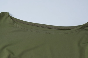 Close-up of olive green crew neck and fine knitted texture on a fitted summer dress