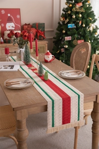Close-up of woven linen table runner with red and green stripes and fringe details